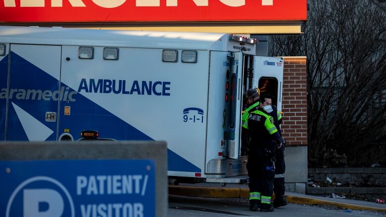 Photograph of ambulance paramedics unloading patients outside a Toronto hospital.