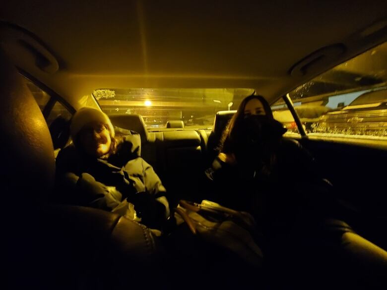 Photo of two people in dark car.