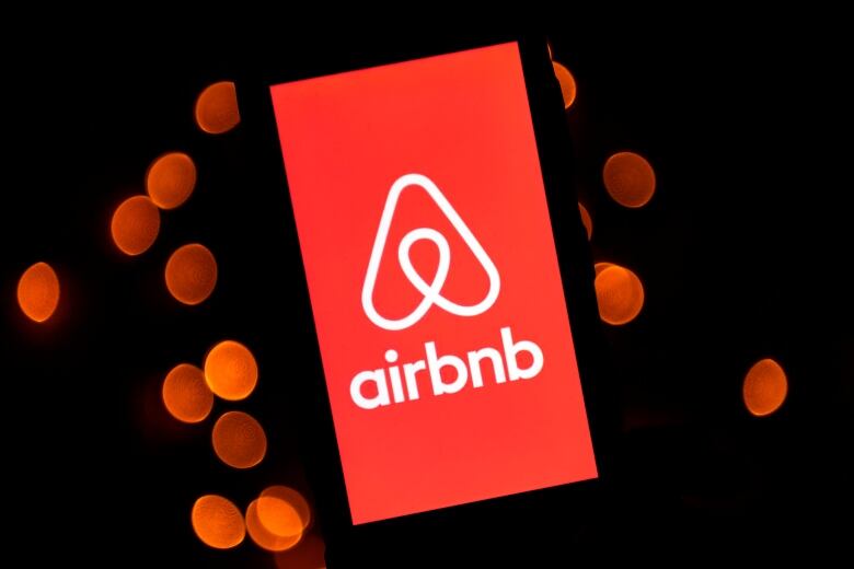 This illustration picture taken on November 22, 2019, shows the logo of the online lodging service Airbnb displayed on a smartphone in Paris.