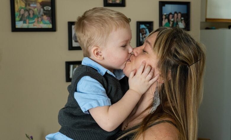 A woman holds a child.