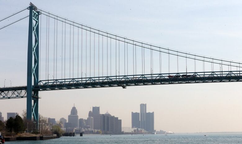 FILE- This April 29, 2015 file photo shows the Detroit skyline under the Ambassador Bridge. Most of the arguments made in a lawsuit by Ambassador Bridge owner Manuel Matty Moroun in his effort to stop the construction of a $2.1 billion competing government span were dismissed in federal court, Wednesday, Sept. 30, 2015. The remaining item involves an international crossing agreement between Michigan and Canada.  (AP Photo/Carlos Osorio, File)