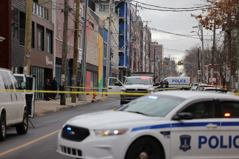 Police cars and caution tape on a Halifax street.