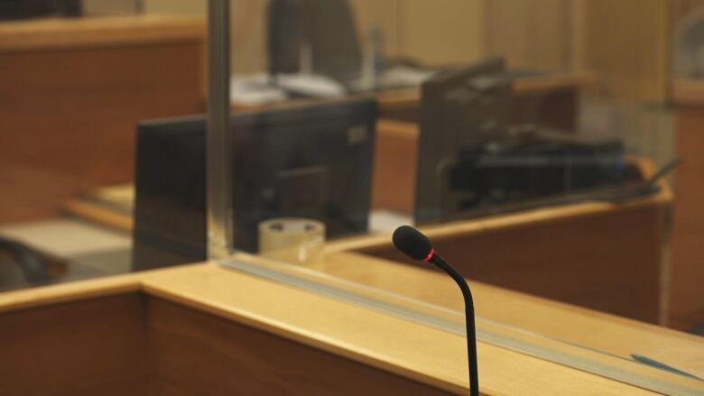 A microphone stands alone in a court.