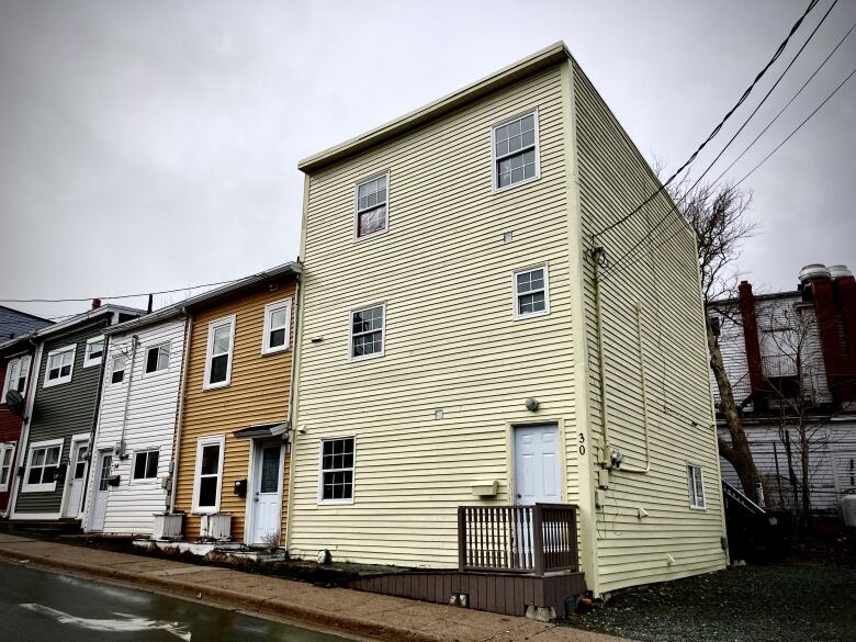 A yellow three-storey house. 