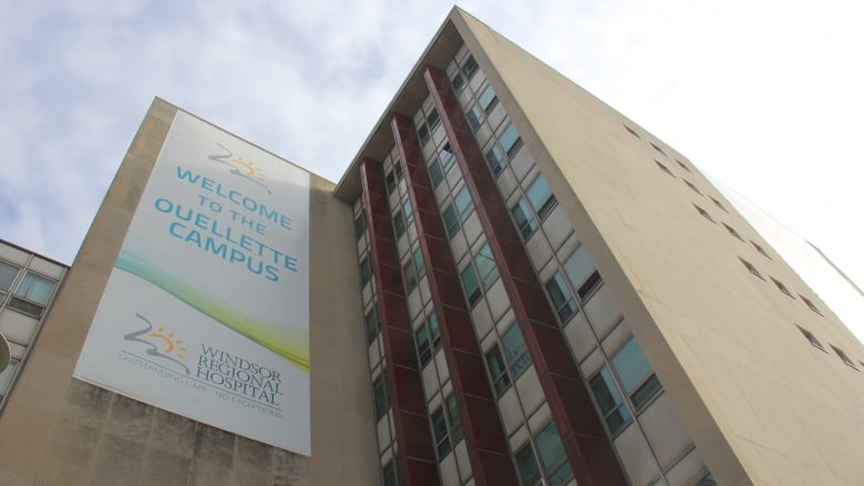 A low angle of a tall, hospital building. 