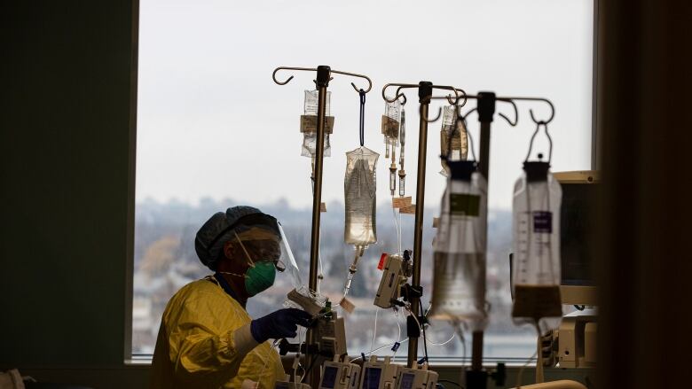 A nurse attends to a COVID-19 positive patient in the Humber River Hospital intensive care unit on Jan. 13, 2022.