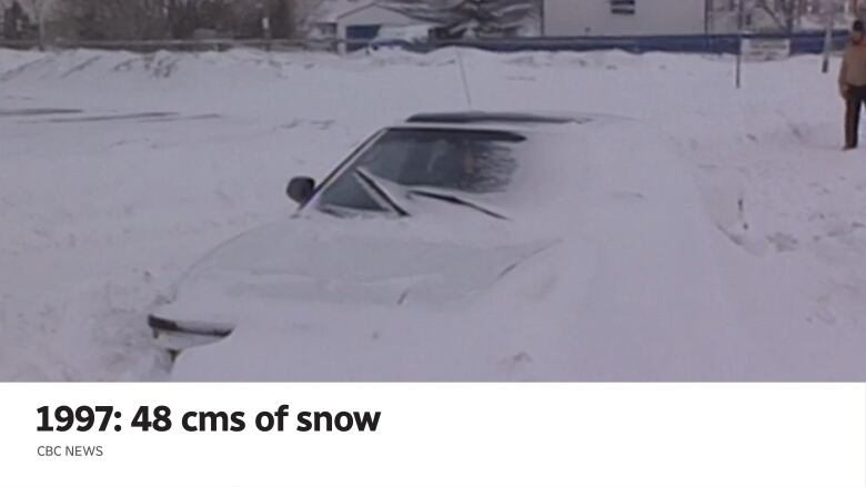 Part of a car pokes out from a big snowdrift