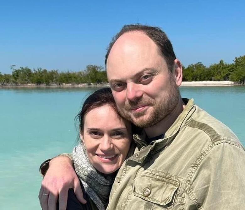 A man and a woman embrace in a photo.