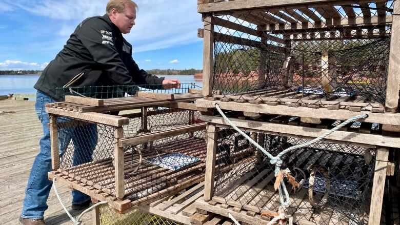 Charlie McGeoghegan at work on his lobster traps on the wharf.