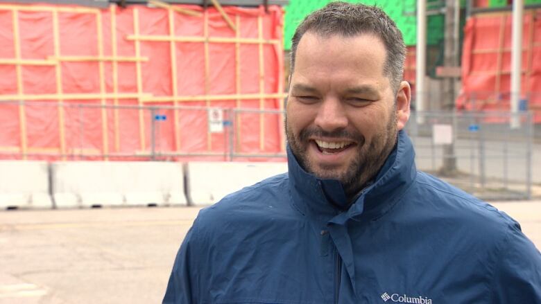 Derek Mombourquette stands in front of the NSCC Waterfront campus in Sydney