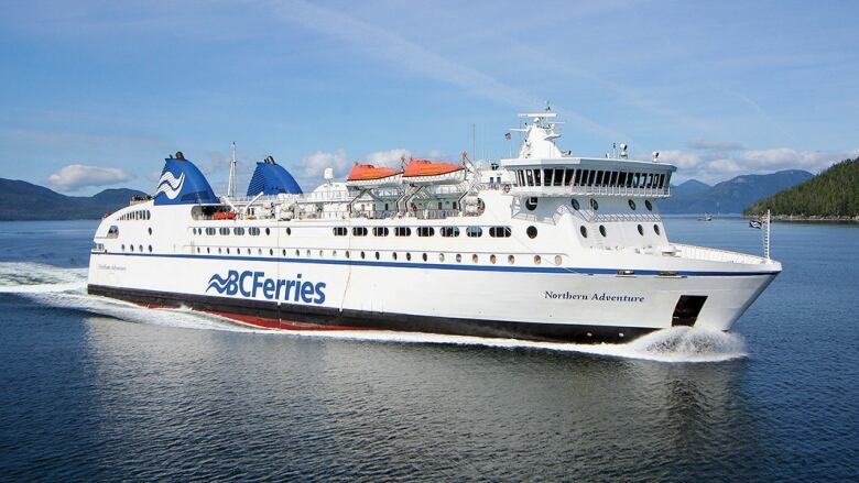 A ferry titled 'Northern Adventure' sails on the sea. It has an orange top.