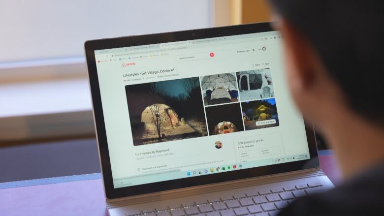  A person is shown looking at airbnb website.