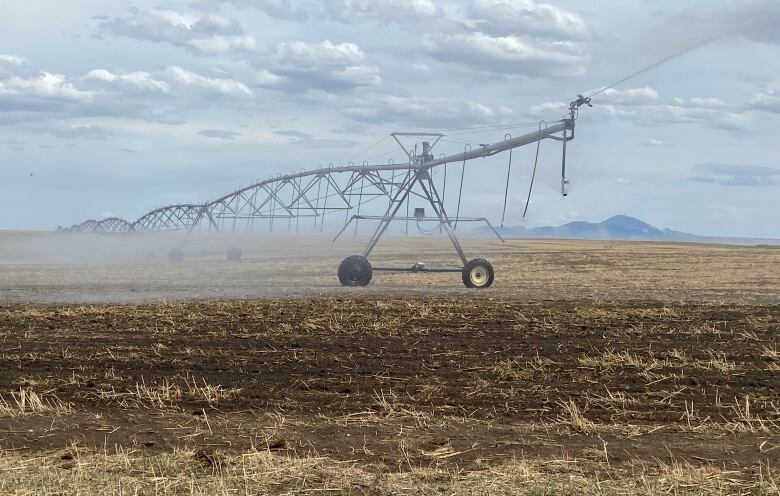 An irrigator rests in a field.