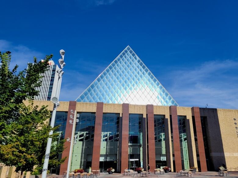 City hall windows reflect sunlight on a summer day. 