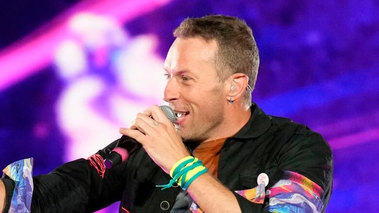 Lead singer of Coldplay Chris Martin performs on stage.