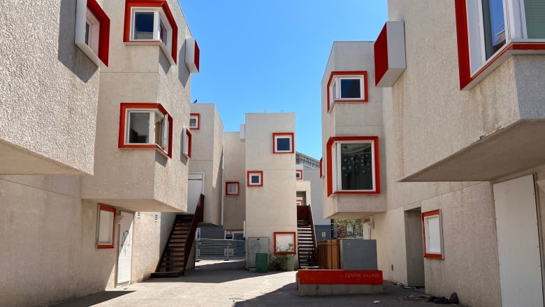 Beige modular buildings with orange frames around windows.