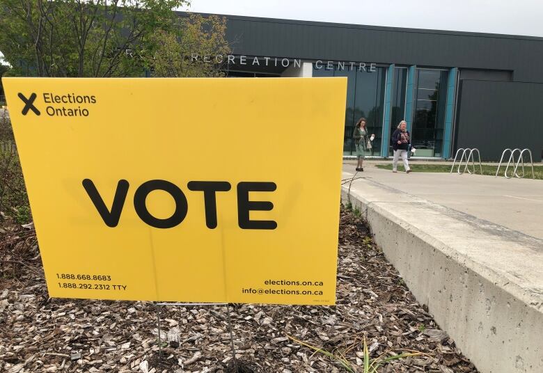 Elections Ontario yellow sign in saying 'VOTE,' posted outside a recreation centre. 