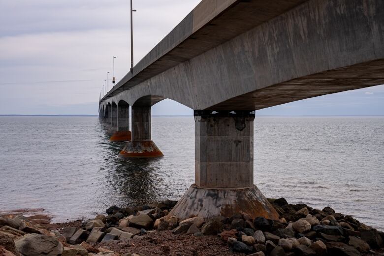 A long cement bridge over a body of water.