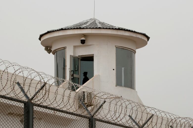 A guard stands in a watchtower of Kashgar prison in Kashgar, Xinjiang Uyghur Autonomous Region, China, May 3, 2021. Picture taken May 3, 2021.