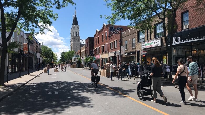 People are in the middle of the street. 