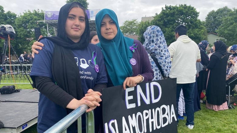 Protesters hold a sign asking to end Islaophobia