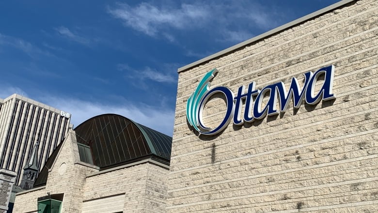 The Ottawa logo on its city hall on a sunny day.