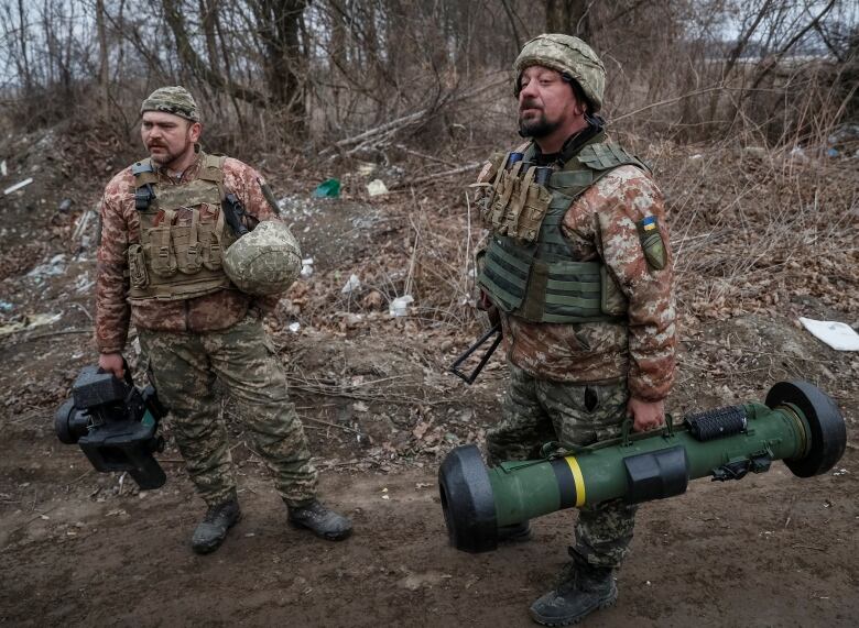 Ukrainian service members hold a Javelin missile system, at a position on the front line in the north Kyiv region.