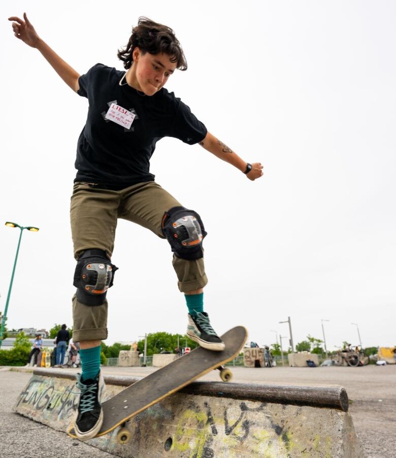 A person concentrates as they perform a skateboard trick.