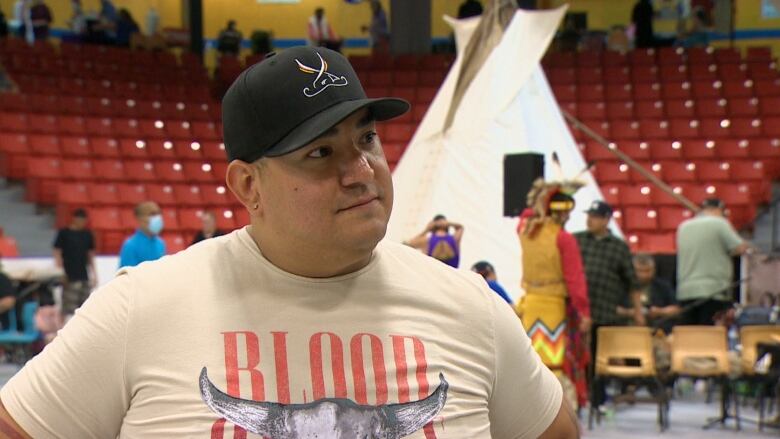 Garrett Gloade, one of the powwow coordinators, in seen being interviewed.