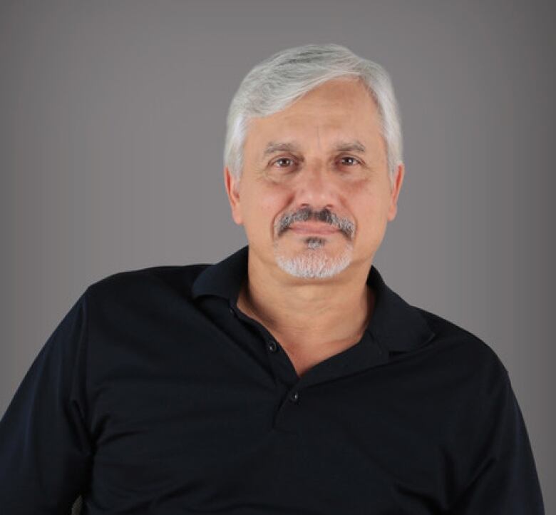 A headshot of Brian Porter, dressed in a black collared shirt. 