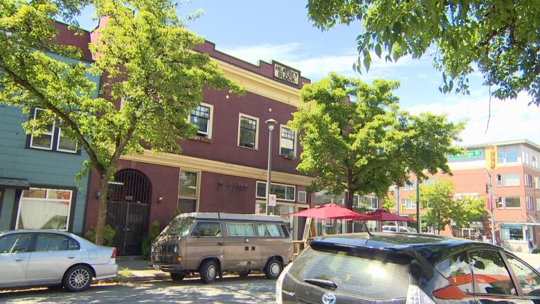 A two-storey brown building with the name 'HEATLEY BLOCK' above it in bold.