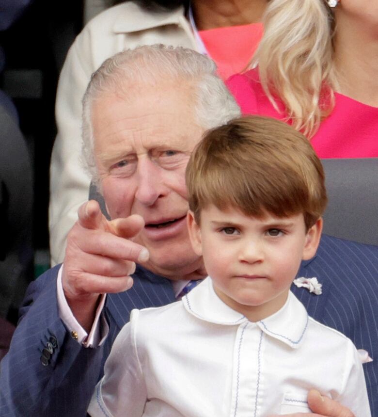 A child sits with a man.