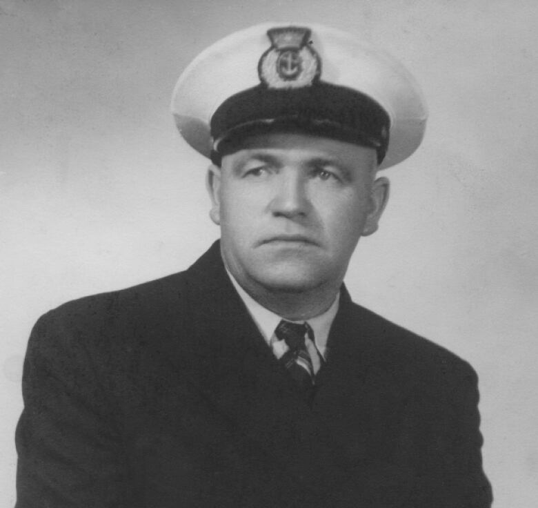 A black and white portrait of a man in a ship captain's uniform.