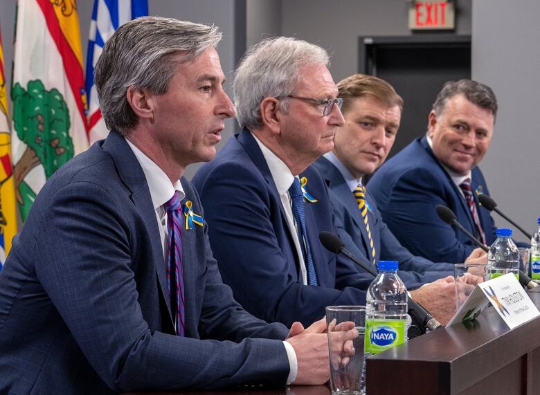 Four men in suits. 