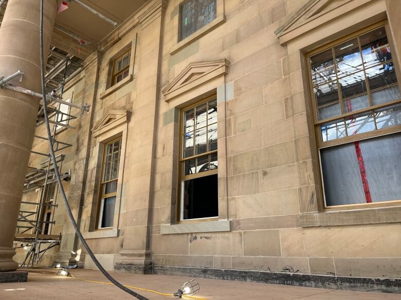 Outside of old stone building, with scaffolding.