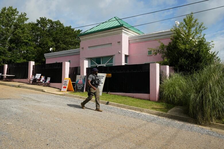 A security officer walks past the front of an abortion clinic.