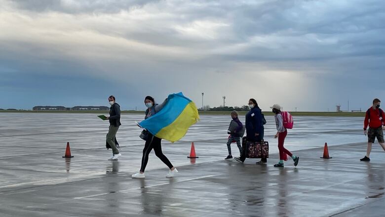 A group of people carrying a flag.