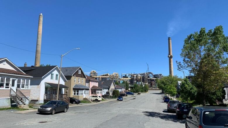 A residential street with a smelter at the end of the street.