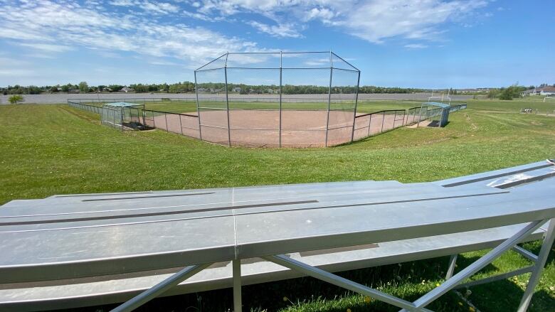 Empty sports field with empty spectator stands.