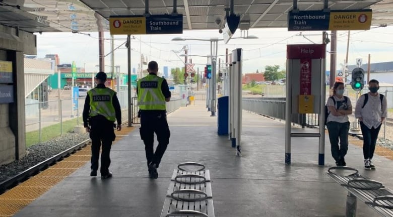 Security guards at a train station platform