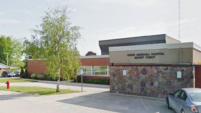 One level brick and stone building with the words Louise Marshall Hospital Mount Forest.