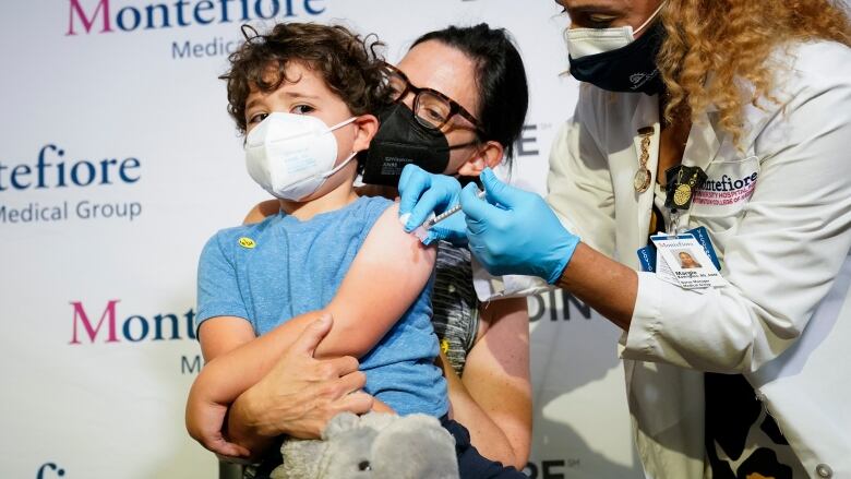 A young boy gets a vaccine.