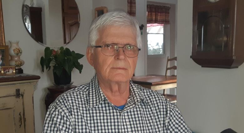 An elderly man sitting in a home.