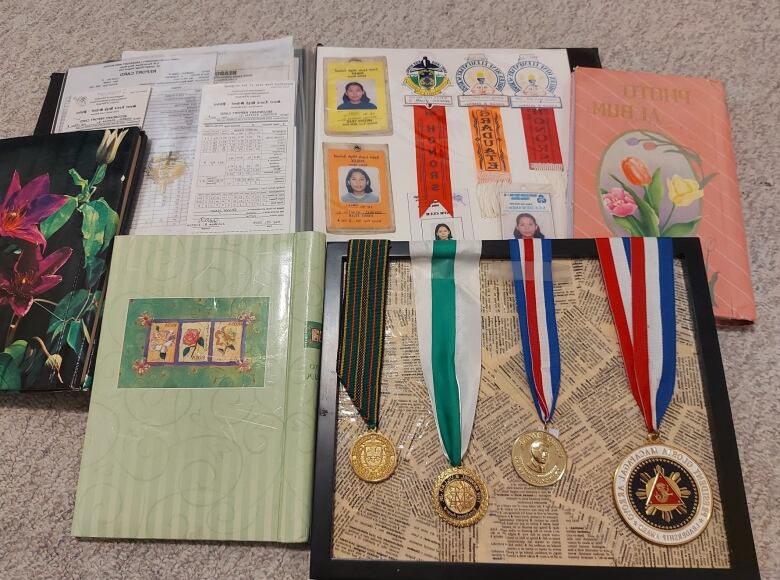 A collection of award medals and photo albums.