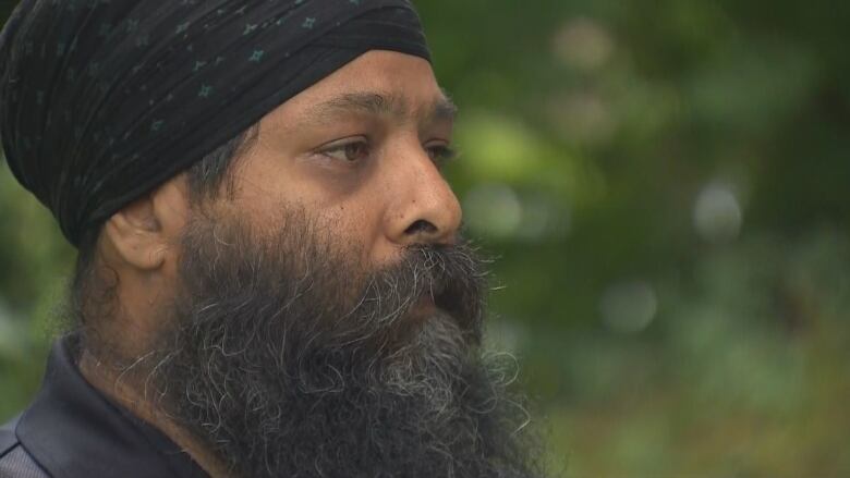 Jaspreet Singh Malik speaks to CBC News outside his home on Friday, a day after his father Ripudaman Malik was shot to death in the city.