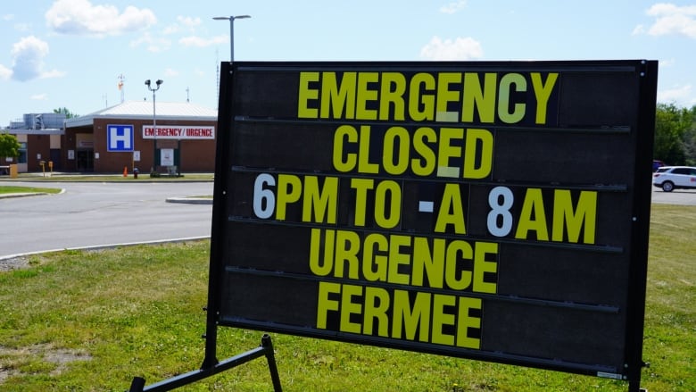 A sign tells people an emergency room at a hospital is closed between 6 p.m. and 8 a.m.