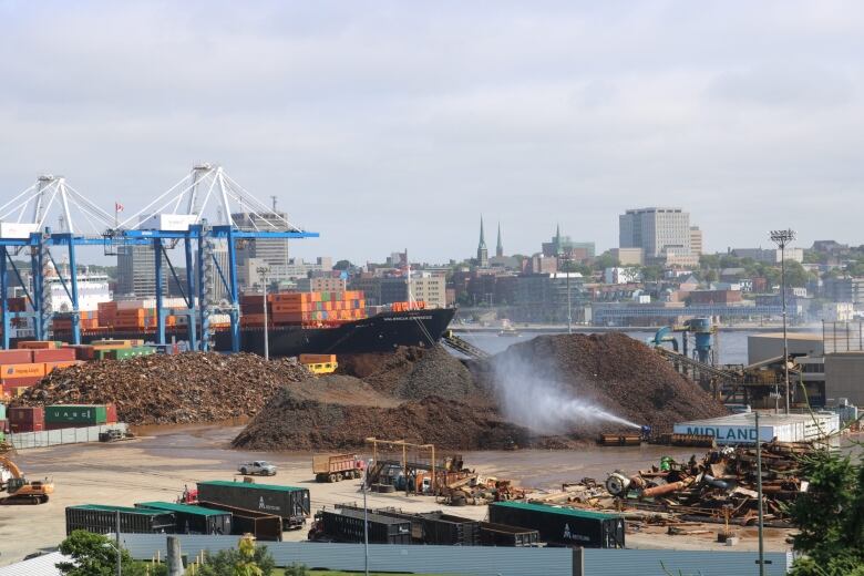 A scrap yard with harbour in background