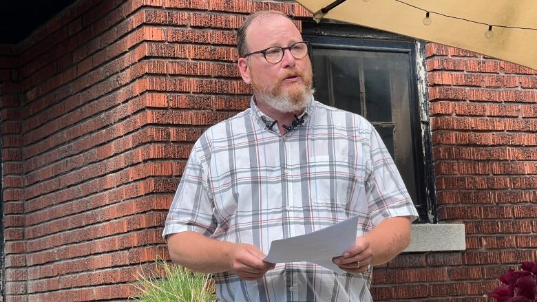 Mayoral candidate Chris Holt speaking on his back deck.