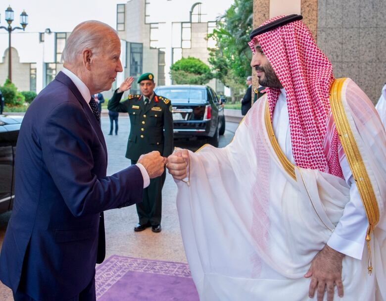 In this image released by the Saudi Royal Palace, Saudi Crown Prince Mohammed bin Salman, right, greets President Joe Biden with a fist bump after his arrival at Al-Salam palace in Jeddah, Saudi Arabia, Friday, July 15, 2022. (Bandar Aljaloud/Saudi Royal Palace via AP)