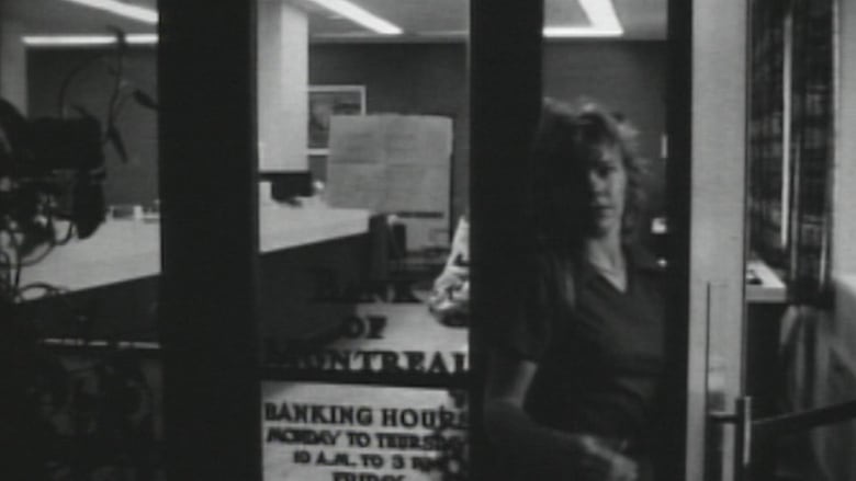 In this archival black and white CBC News image, a woman closes the door of a Bank of Montreal branch at Vancouver General Hospital, after it was robbed at gunpoint on April 27, 1971. It was at the time the largest bank robbery in B.C. history, in which gunmen stole $2.4 million in today's money.